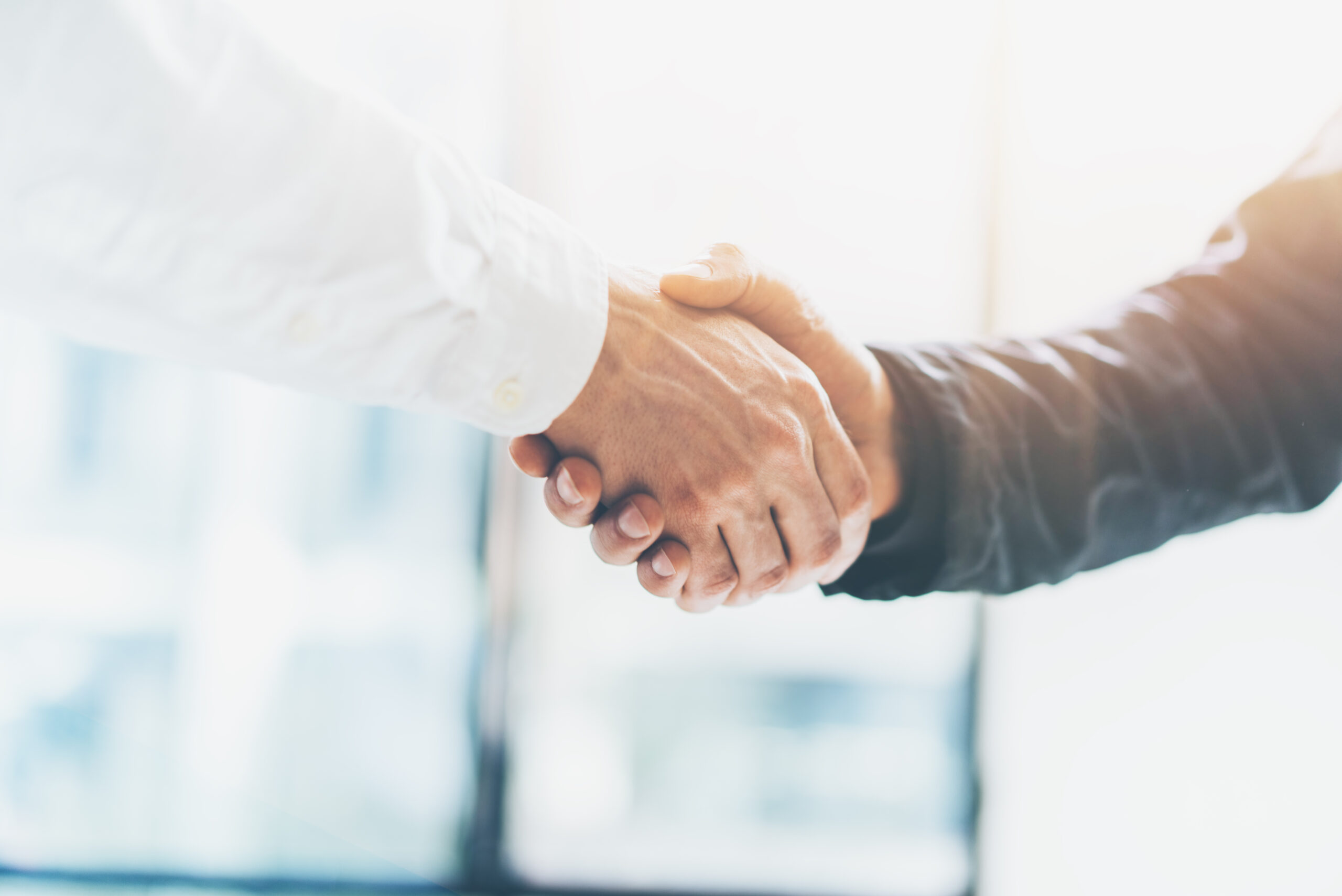Business partnership meeting. Picture businessmans handshake. Successful businessmen handshaking after good deal. Horizontal, blurred background Handshake Image